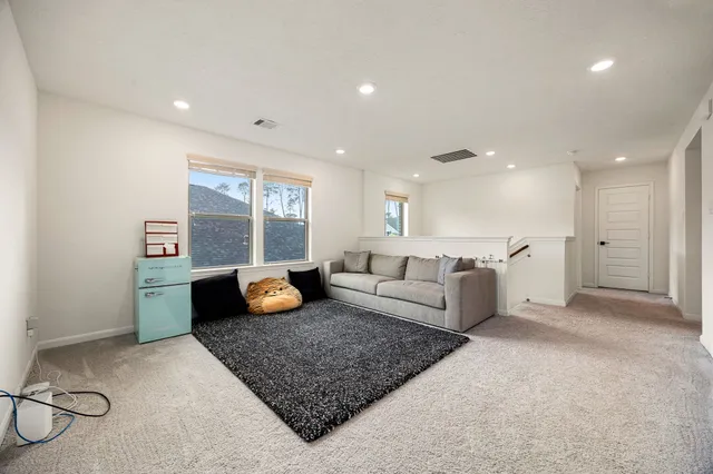 a living room with furniture and a rug