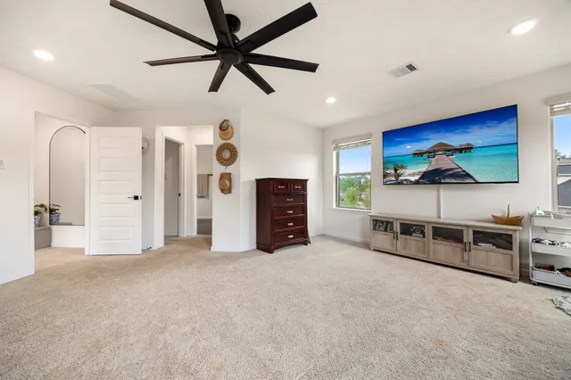 a view of a livingroom with furniture and a ceiling fan