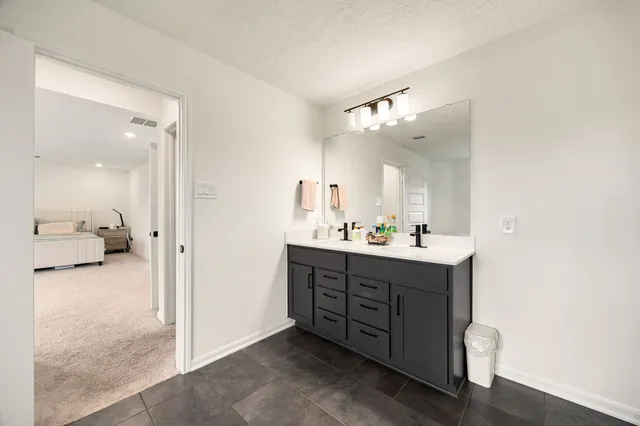 a spacious bathroom with a double vanity sink double and mirror