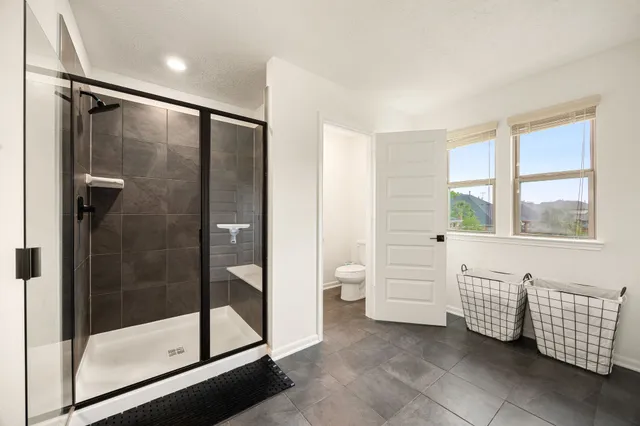 a bathroom with a bathtub and a shower