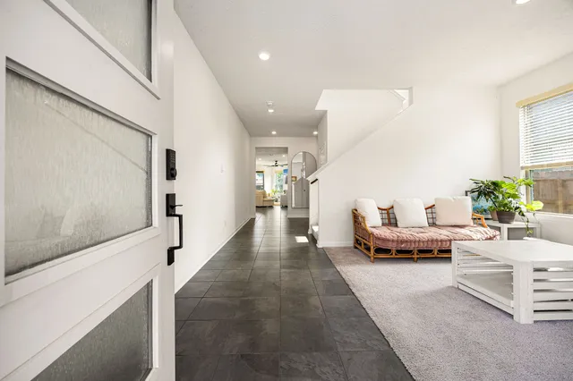 a living room with furniture and a potted plant