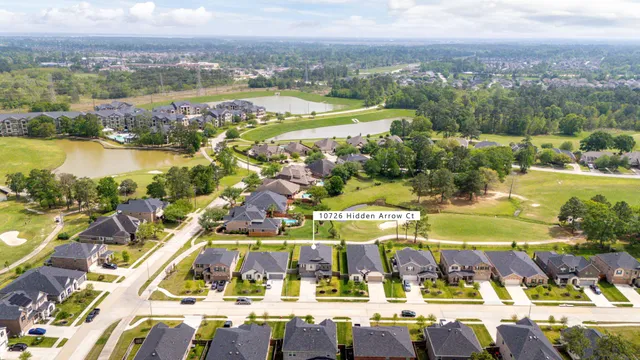 an aerial view of residential houses with outdoor space and river