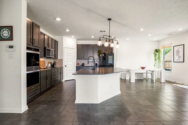 a large white kitchen with a large counter top furniture and kitchen view