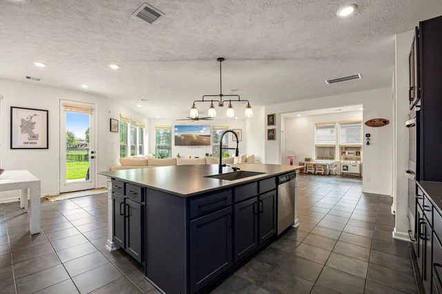 a kitchen with a sink and chandelier