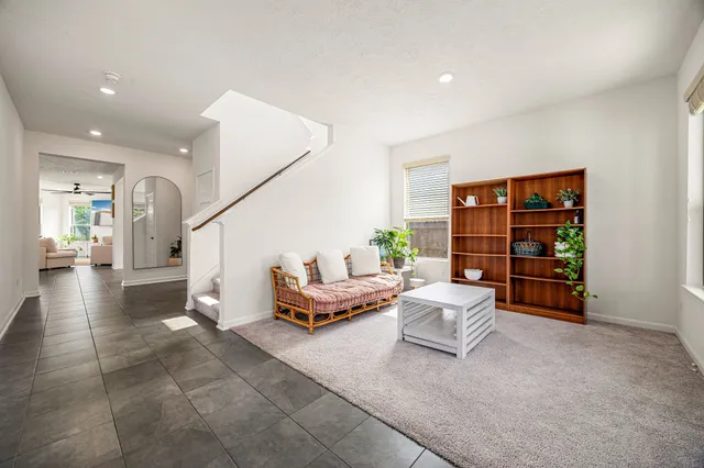 a living room with furniture and stairs