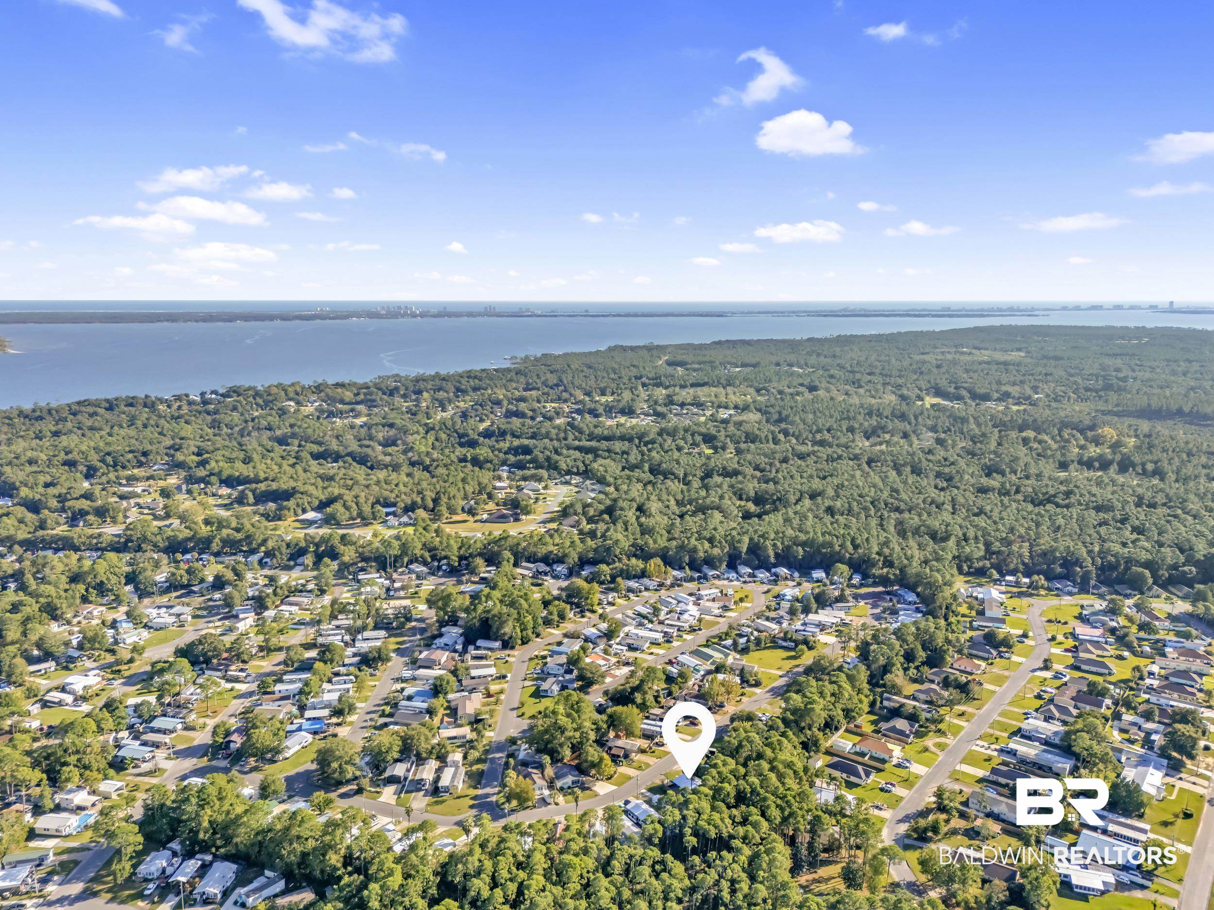 182 Defuniak Loop Lillian, AL 36549 - Photo 17 of 21 Aerial perspective of suburban area featuring a forest and a large body of water