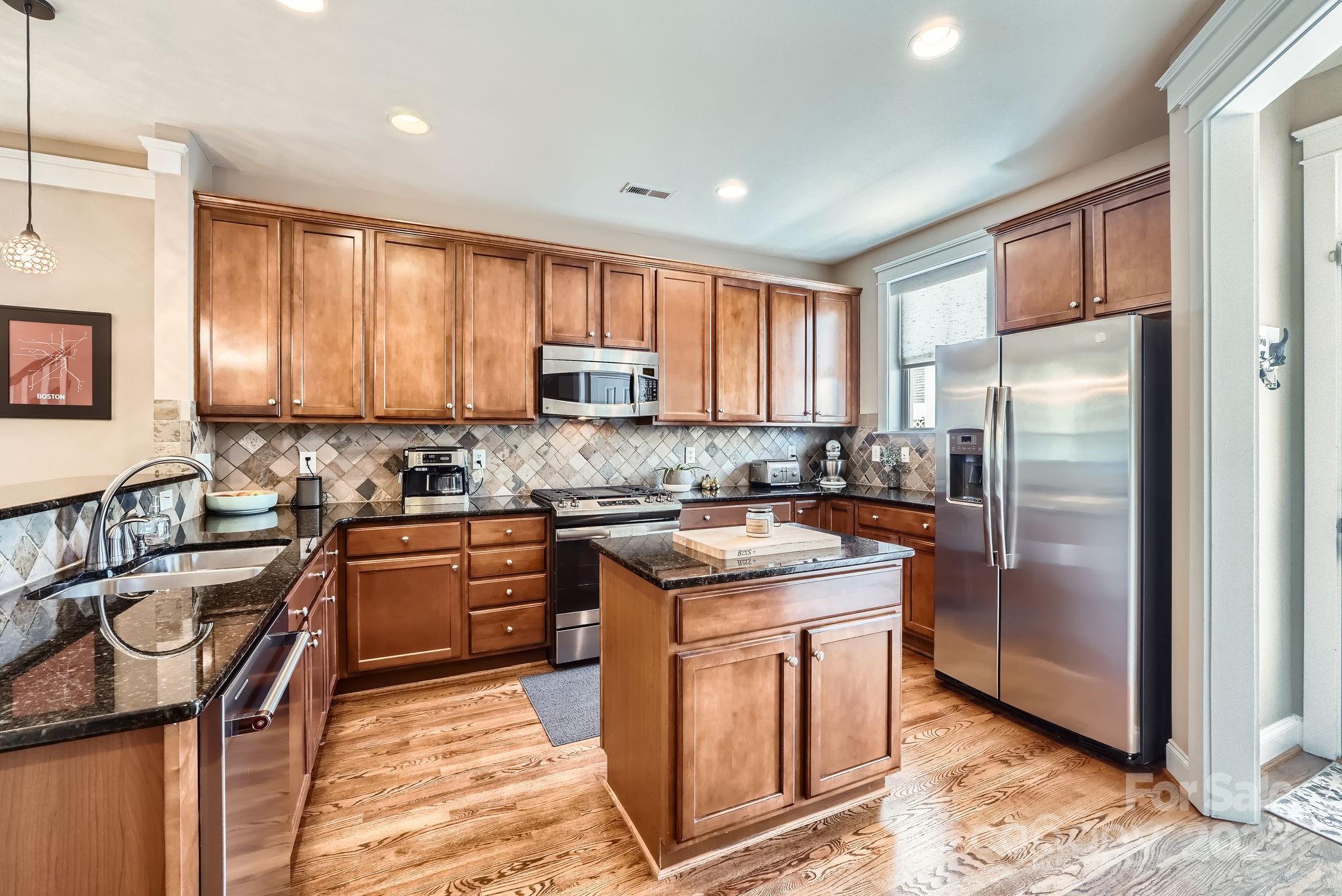 275 Bridges Farm Road Mooresville, NC 28115 - Photo 11 of 48 a kitchen with stainless steel appliances granite countertop a stove a sink a refrigerator and a microwave