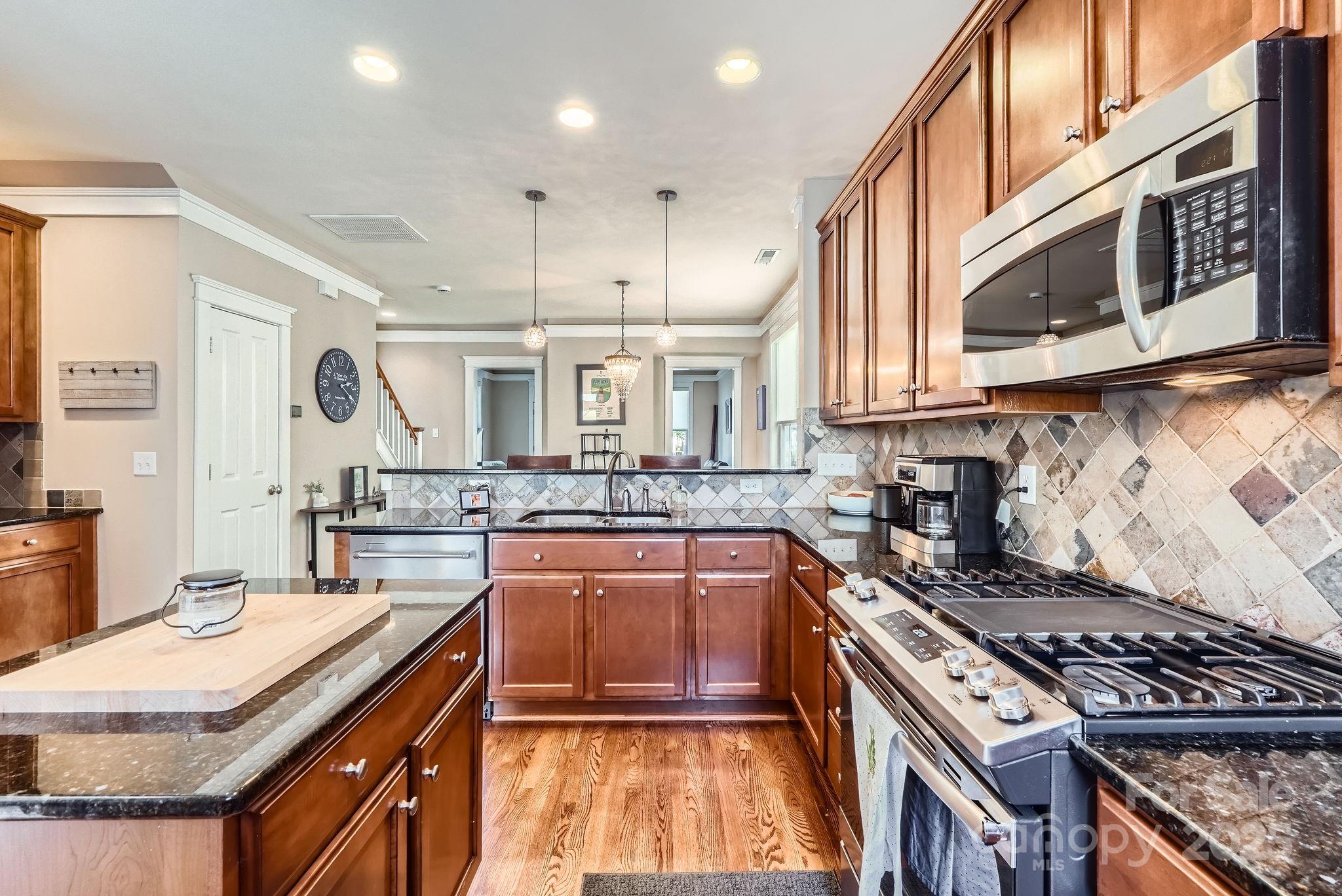 275 Bridges Farm Road Mooresville, NC 28115 - Photo 13 of 48 a kitchen with stainless steel appliances granite countertop a stove and a sink