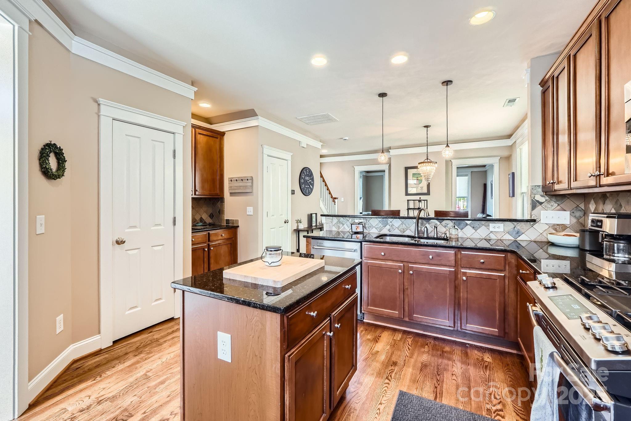 275 Bridges Farm Road Mooresville, NC 28115 - Photo 14 of 48 a kitchen with stainless steel appliances granite countertop a sink a stove and a refrigerator