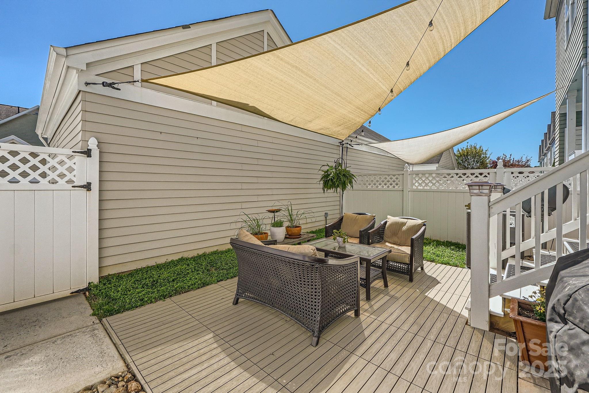 275 Bridges Farm Road Mooresville, NC 28115 - Photo 18 of 48 a view of a patio with table and chairs with wooden floor and fence
