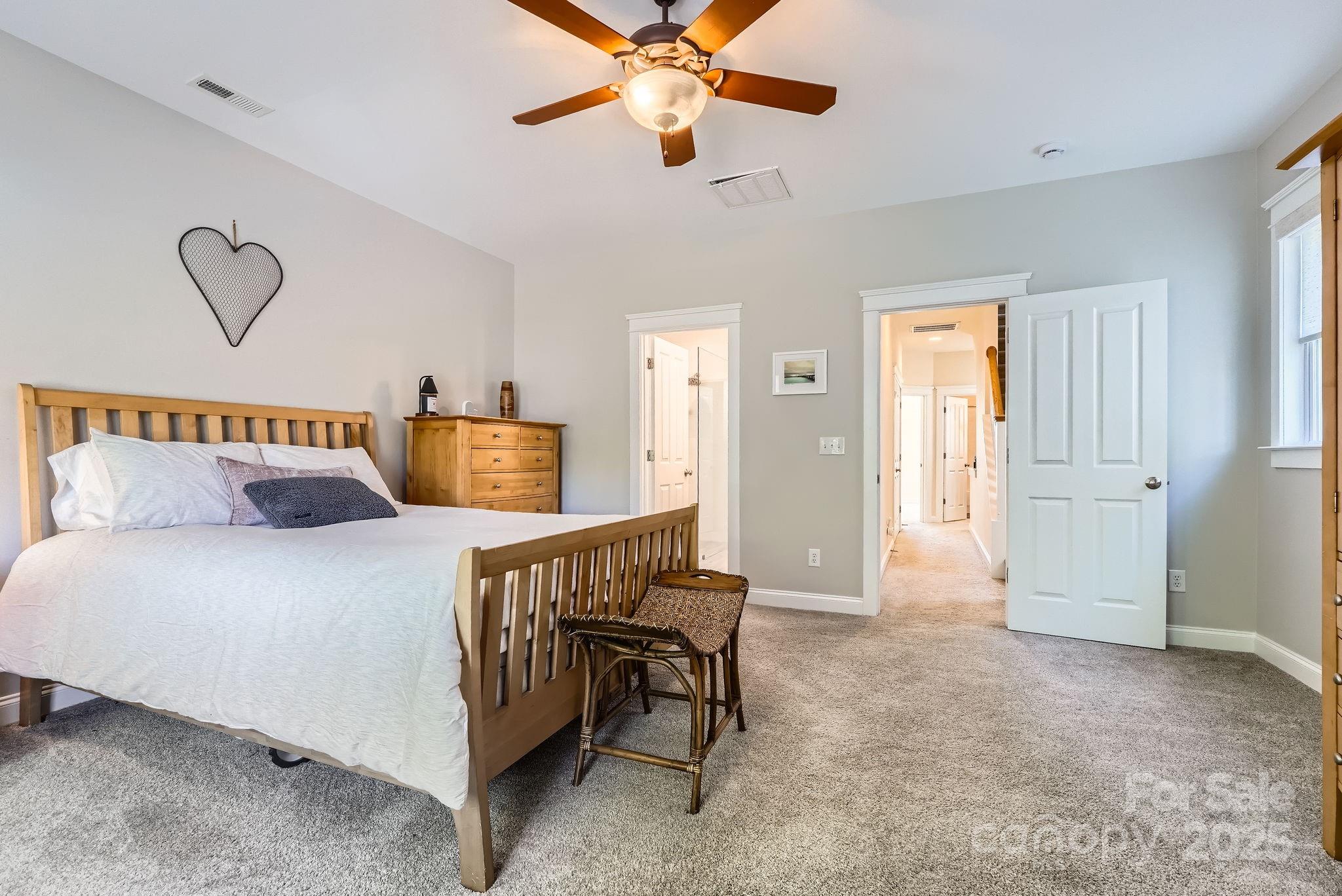 275 Bridges Farm Road Mooresville, NC 28115 - Photo 21 of 48 a bedroom with a bed and a chandelier