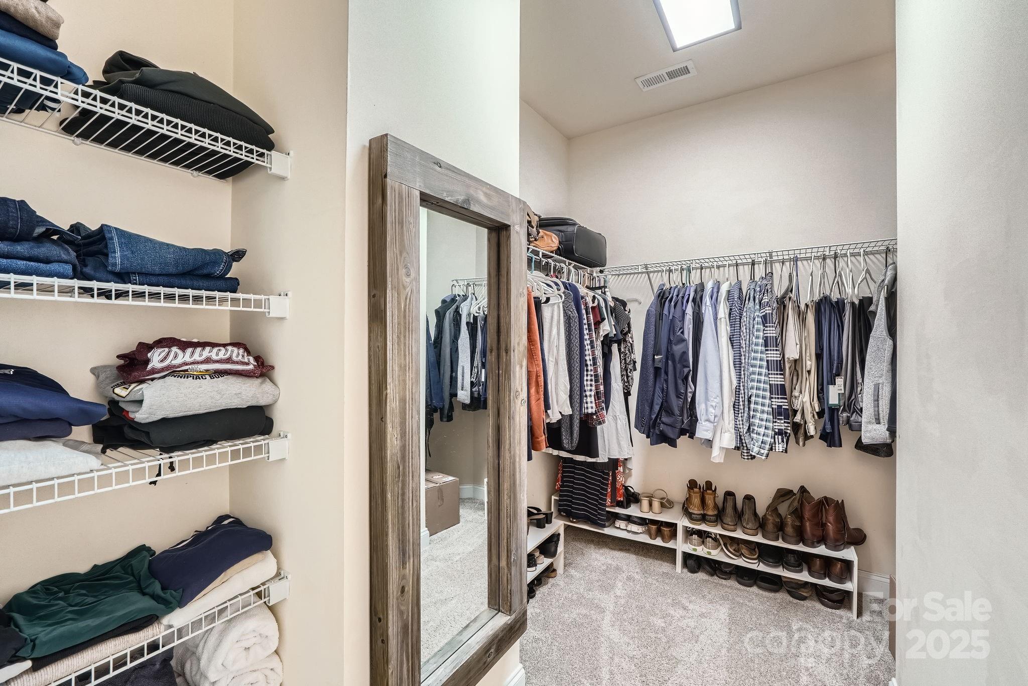 275 Bridges Farm Road Mooresville, NC 28115 - Photo 24 of 48 a view of walk in closet with clothes and shoes