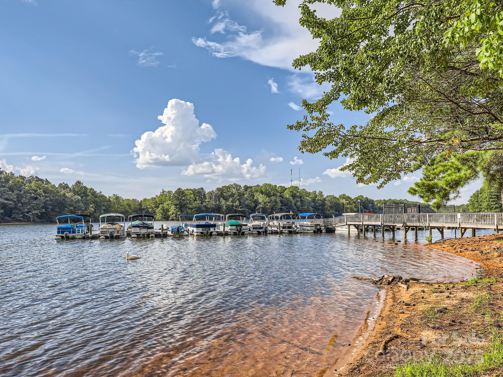 275 Bridges Farm Road Mooresville, NC 28115 - Photo 30 of 48 a view of a lake with lawn chairs