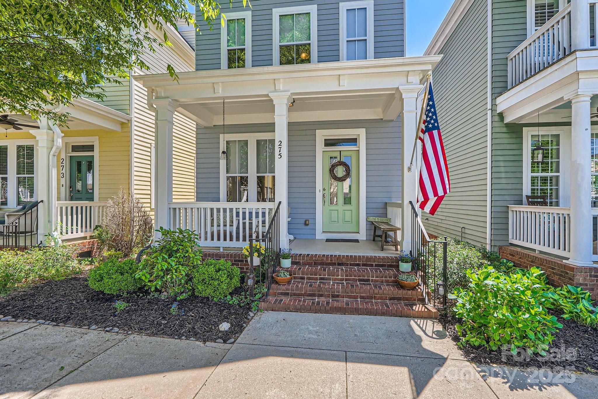 275 Bridges Farm Road Mooresville, NC 28115 - Photo 4 of 48 a front view of a house with a yard and potted plants