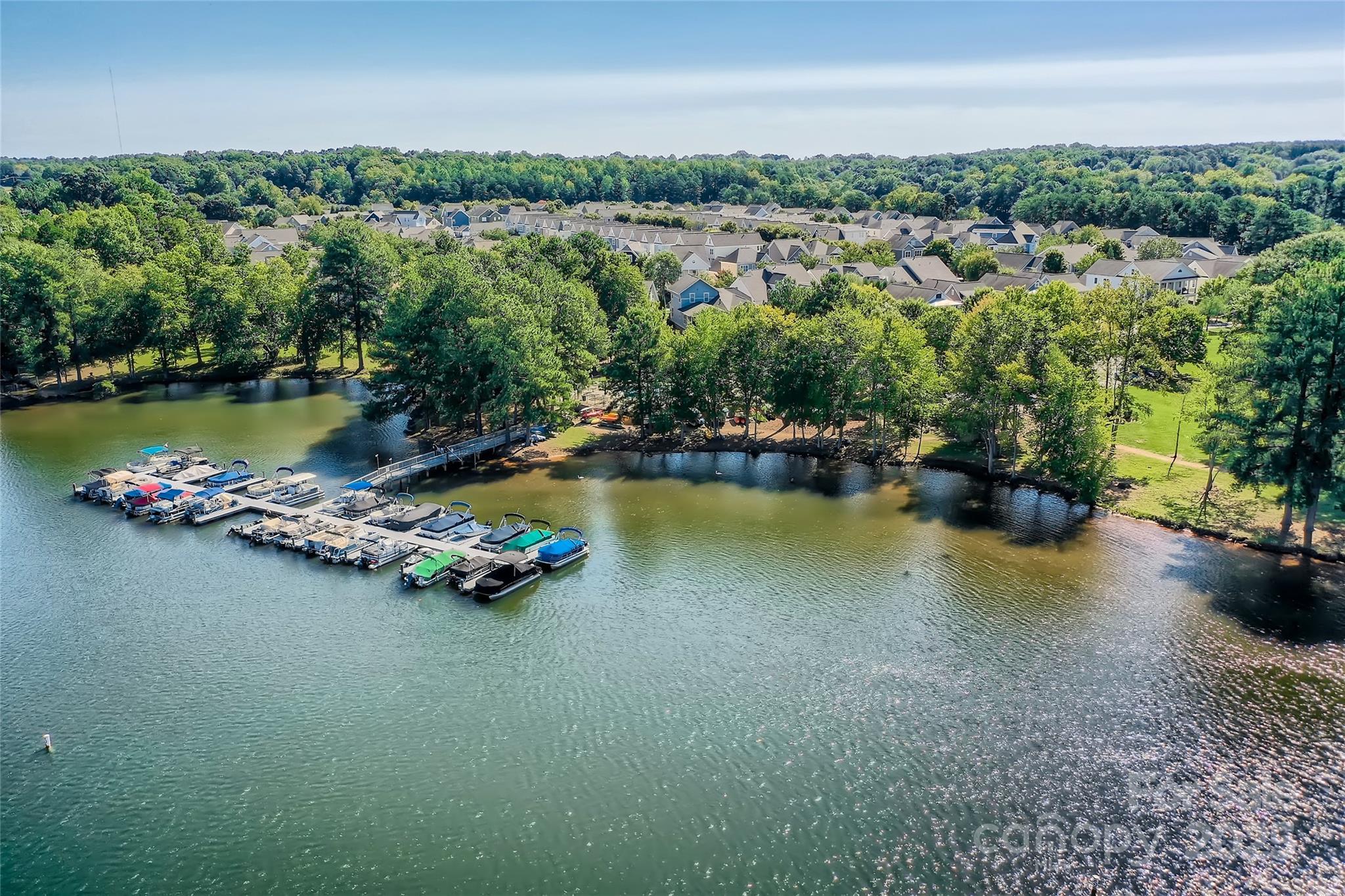 275 Bridges Farm Road Mooresville, NC 28115 - Photo 41 of 48 a view of a lake with boats and trees in the background