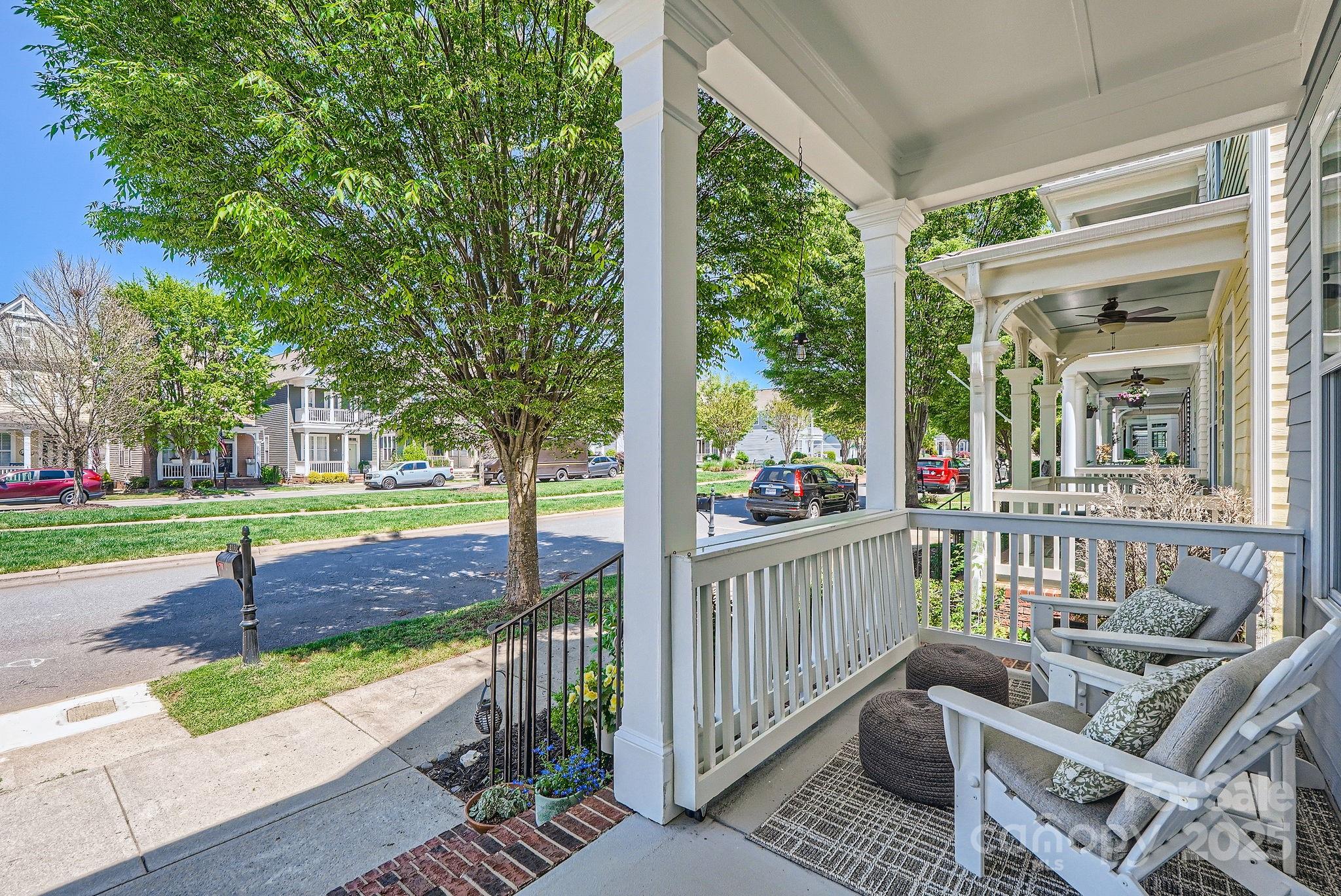 275 Bridges Farm Road Mooresville, NC 28115 - Photo 5 of 48 a view of a patio with couches chairs and wooden fence