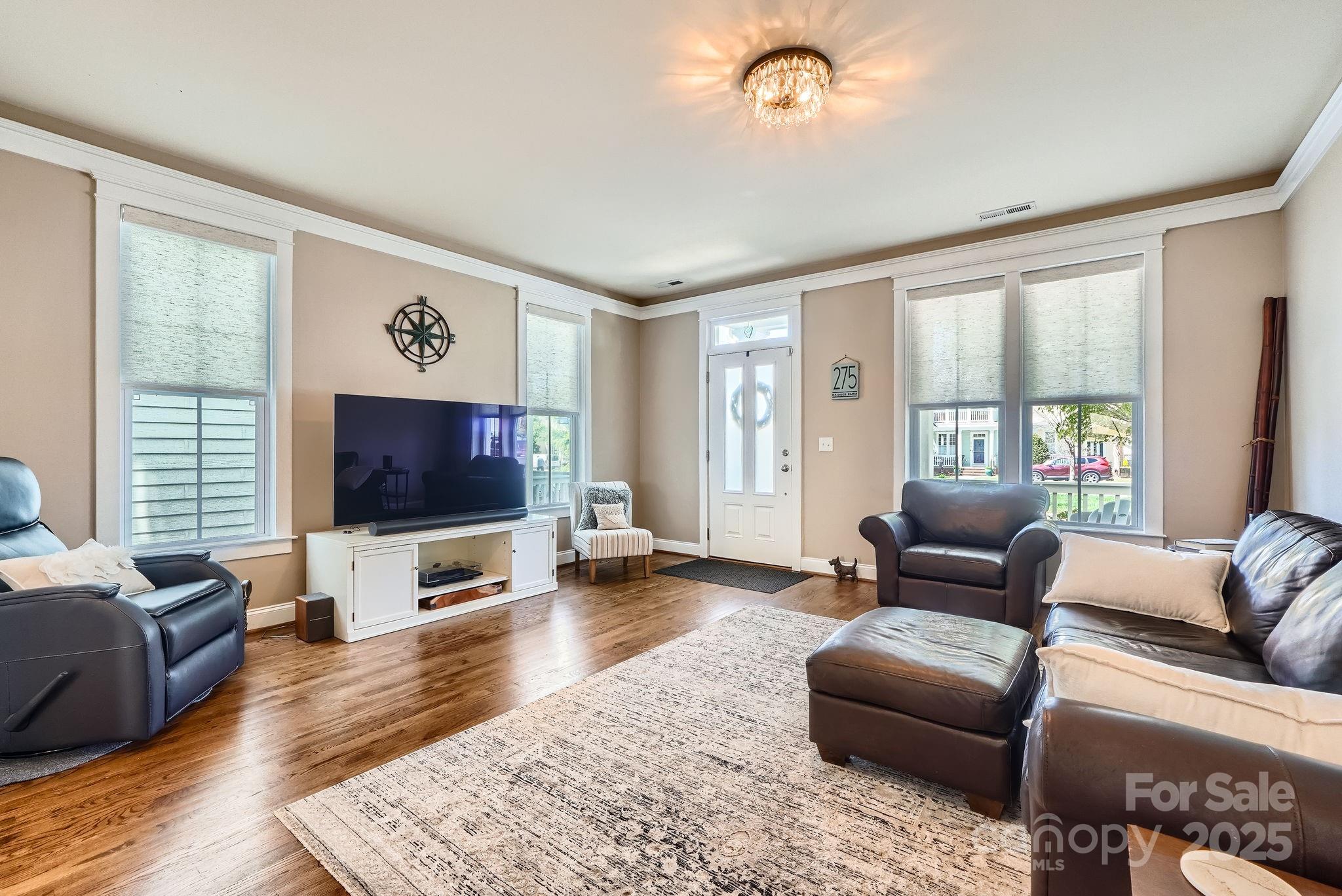 275 Bridges Farm Road Mooresville, NC 28115 - Photo 7 of 48 a living room with furniture and a flat screen tv