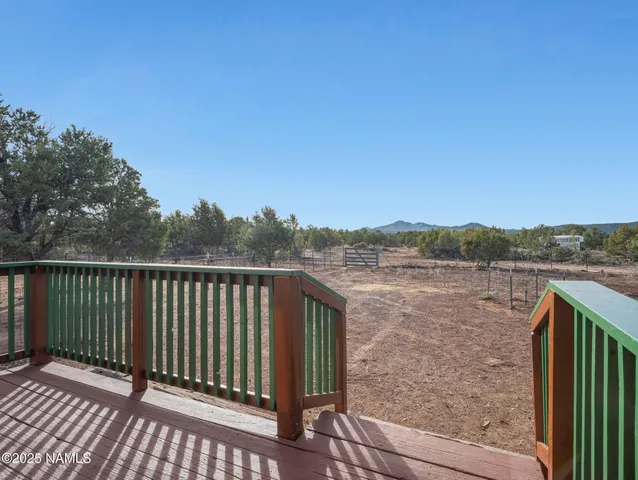 a view of a balcony with wooden floor and lake view