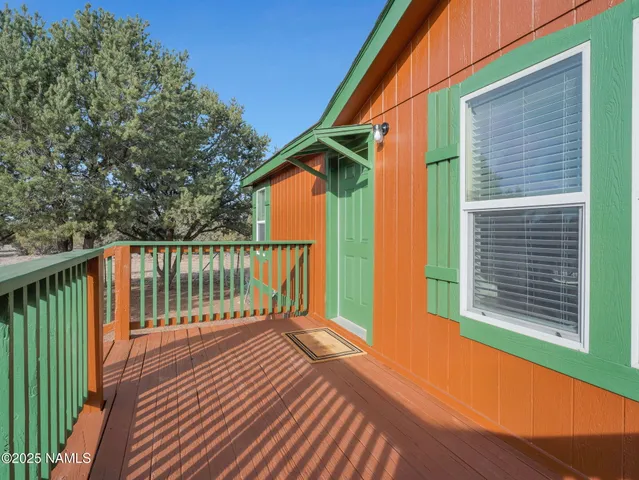 a balcony with wooden floor and fence