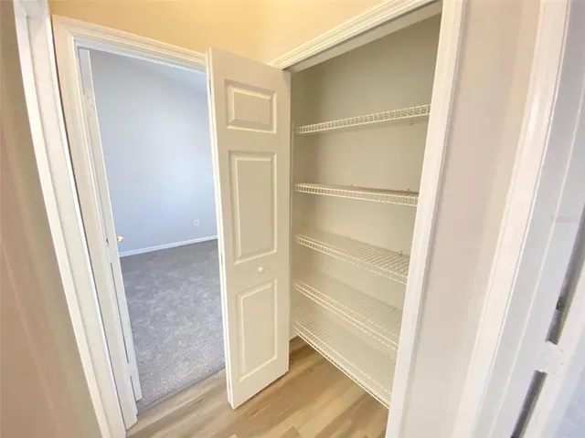 a view of walk in closet with empty racks