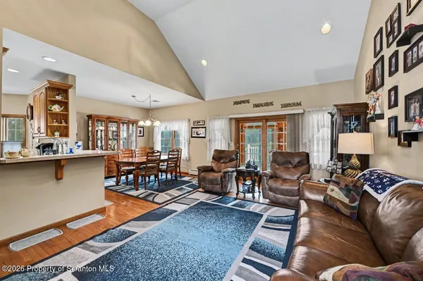 a living room with furniture a window and a flat screen tv