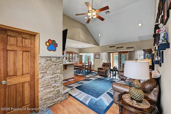 a living room with furniture and large windows