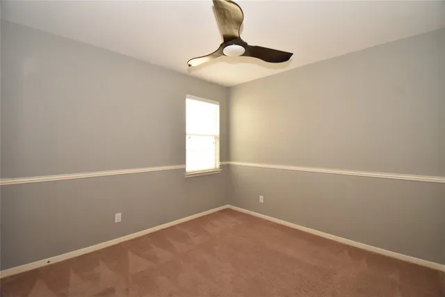 a view of a small space with wooden floor and windows