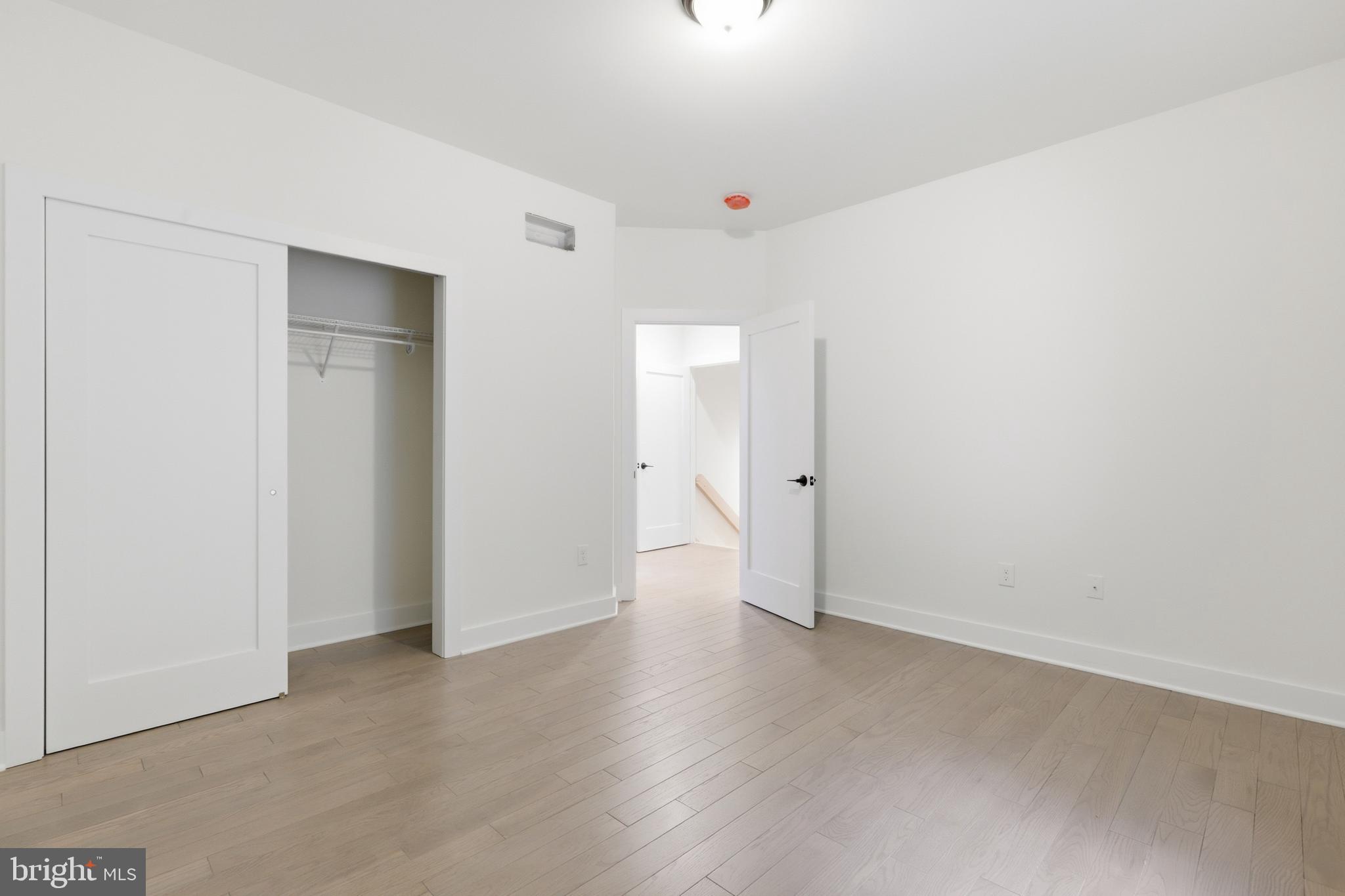 759 River Road Erwinna, PA 18920 - Photo 21 of 46 an empty room with wooden floor and windows