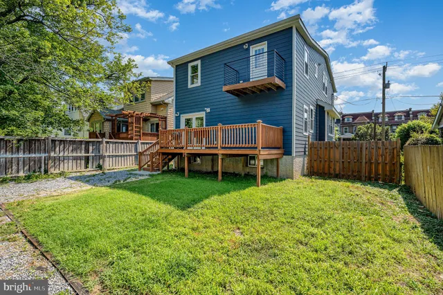 a backyard of a house with wooden fence