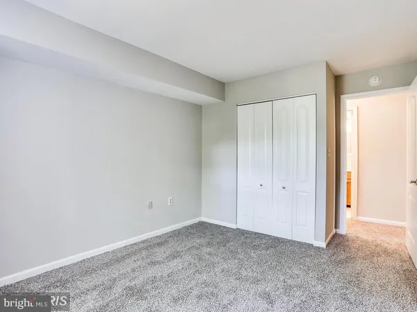 a view of an empty room and closet area
