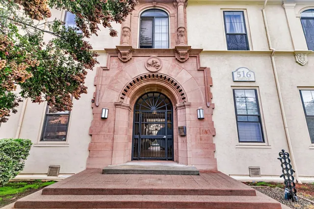 a view of a grey house with large windows