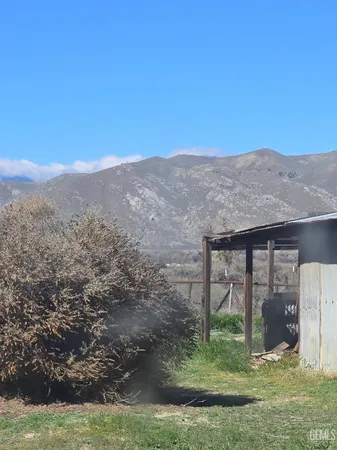 a view of a wooden house with a yard