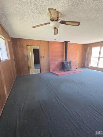 a view of a livingroom with a ceiling fan and window