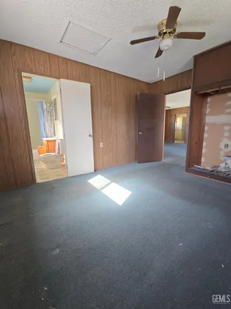 a view of a livingroom with a ceiling fan and window