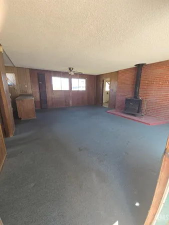 an empty room with stairs and windows