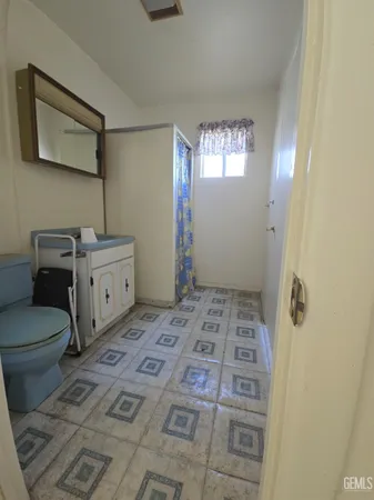 a bathroom with a sink toilet and window