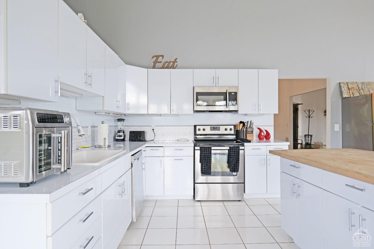 3372 County Road 10 Windham, NY 12496 - Photo 19 of 37 a kitchen with white cabinets and appliances