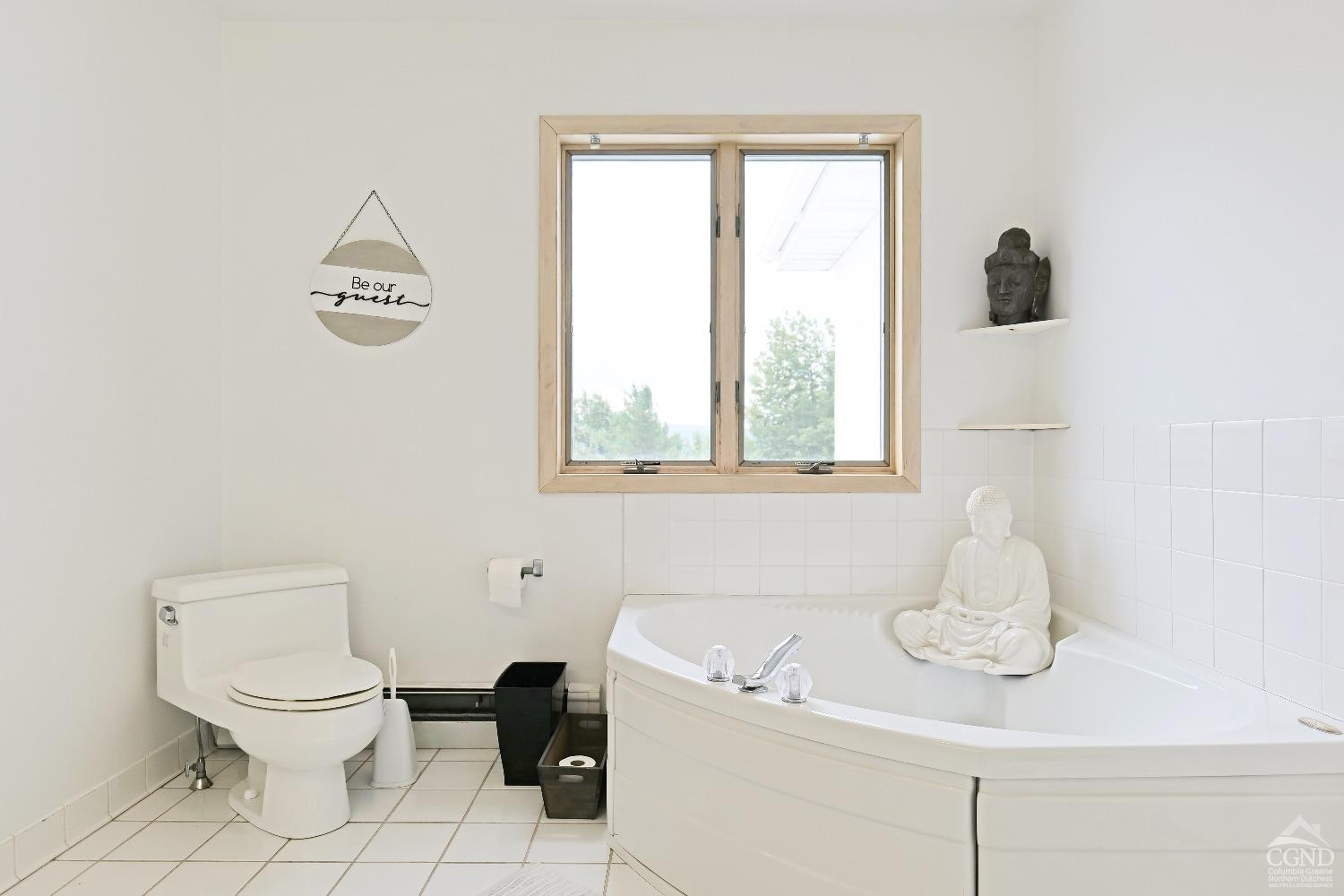 3372 County Road 10 Windham, NY 12496 - Photo 30 of 37 a bathroom with a toilet sink a mirror and window