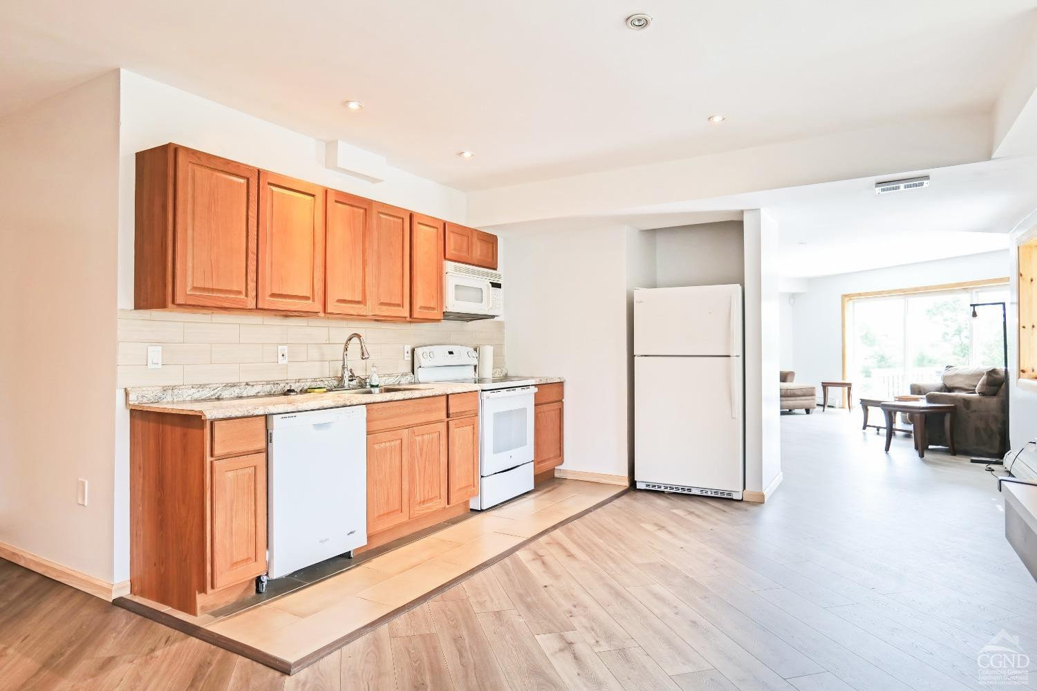 3372 County Road 10 Windham, NY 12496 - Photo 36 of 37 a kitchen with stainless steel appliances granite countertop a refrigerator sink and white cabinets