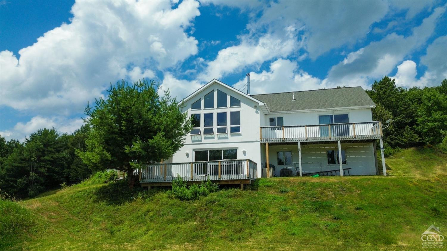 3372 County Road 10 Windham, NY 12496 - Photo 5 of 37 a view of a big house with a big yard and large trees