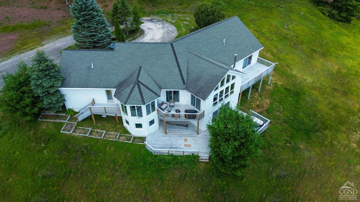 3372 County Road 10 Windham, NY 12496 - Photo 6 of 37 an aerial view of a house with swimming pool garden and mountain view