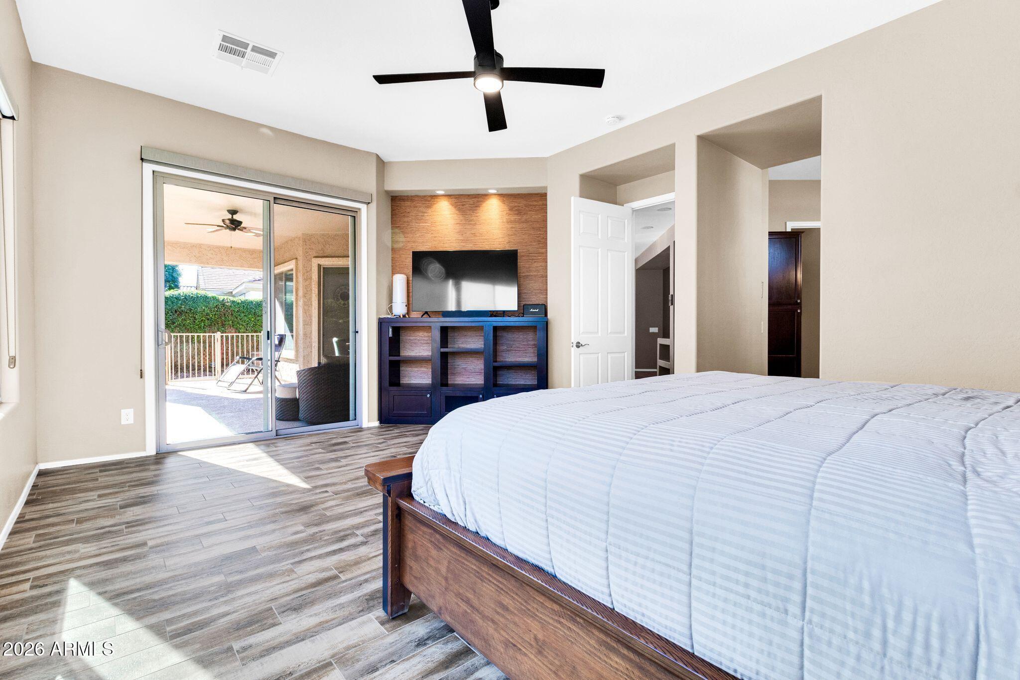 5333 South Marigold Way Gilbert, AZ 85298 - Photo 17 of 69 a spacious bedroom with a bed and wooden floor