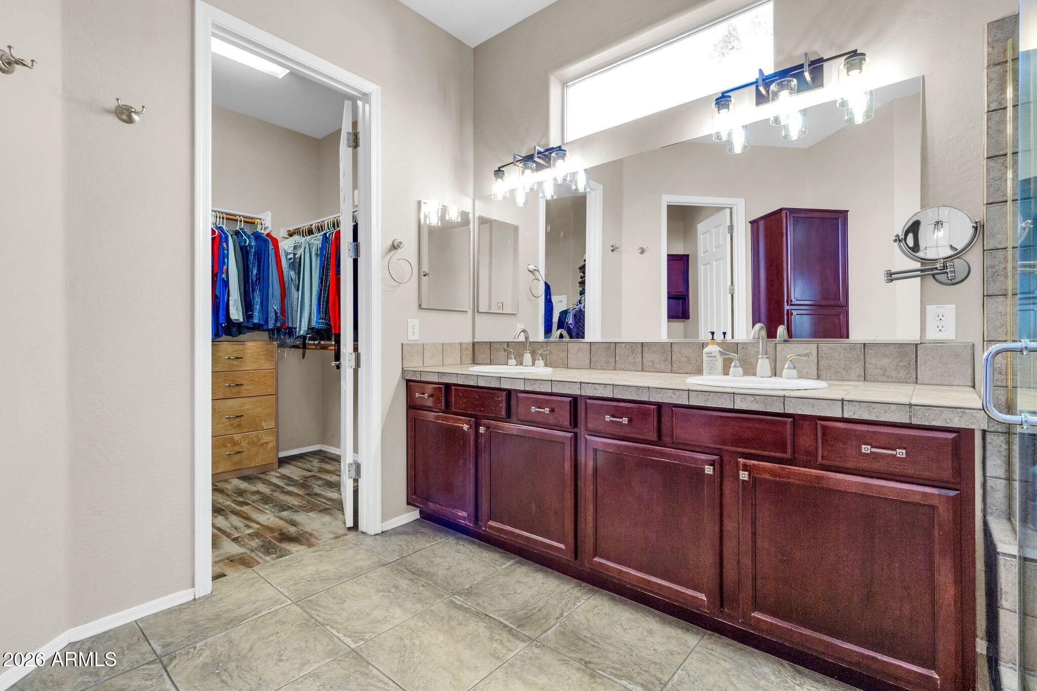 5333 South Marigold Way Gilbert, AZ 85298 - Photo 21 of 69 a bathroom with a granite countertop sink and a mirror