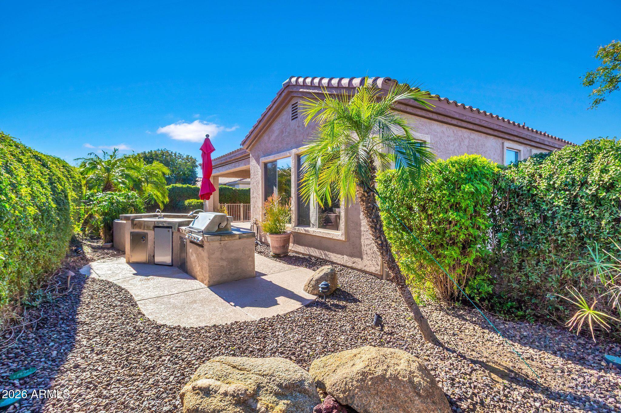 5333 South Marigold Way Gilbert, AZ 85298 - Photo 37 of 69 a view of a patio with table and chairs potted plants