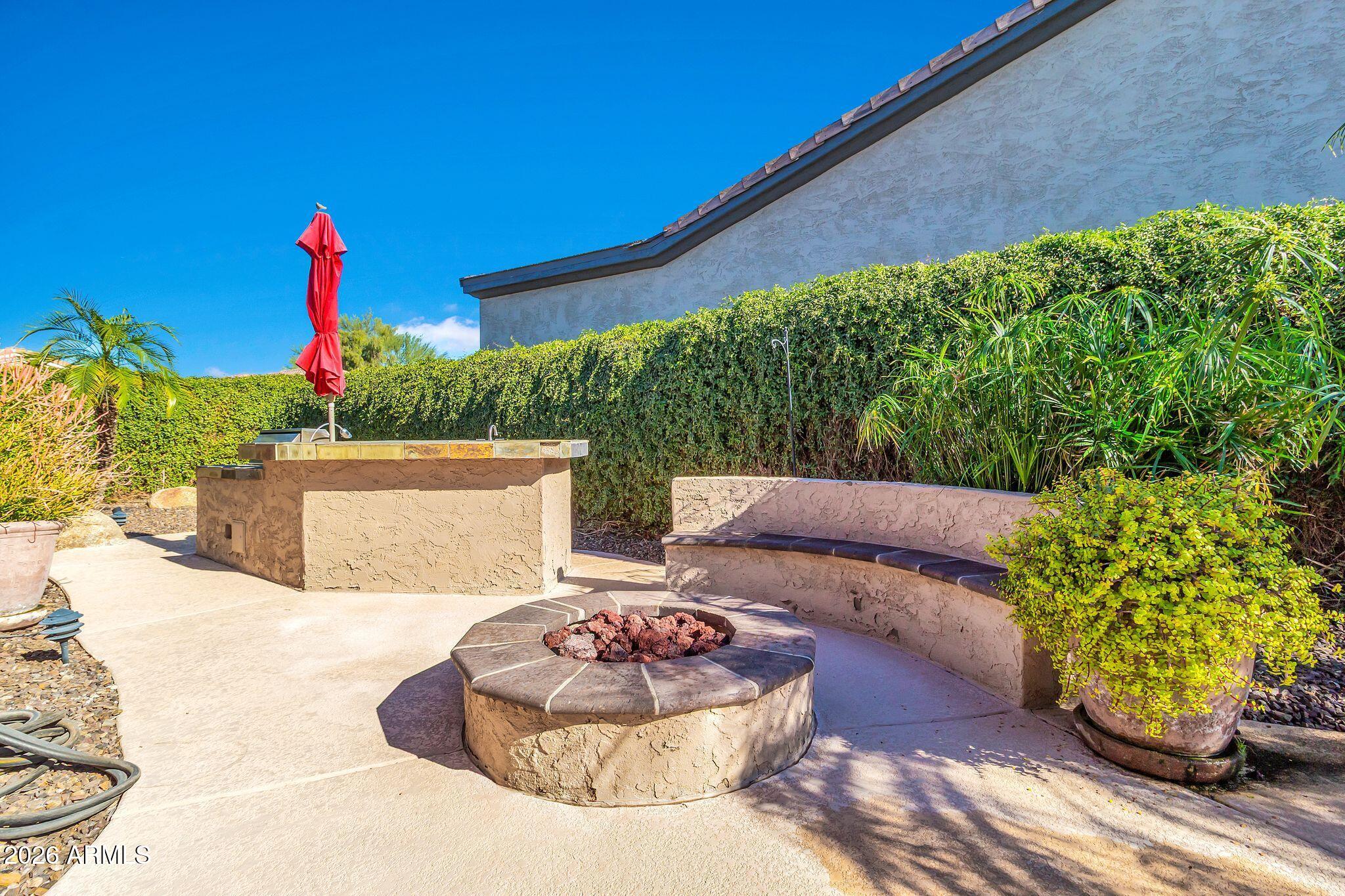 5333 South Marigold Way Gilbert, AZ 85298 - Photo 39 of 69 a wooden bench sitting in front of a building