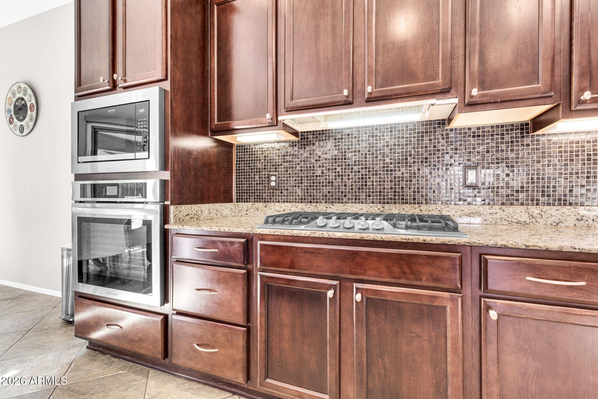 5333 South Marigold Way Gilbert, AZ 85298 - Photo 6 of 69 a kitchen with granite countertop a refrigerator and a sink