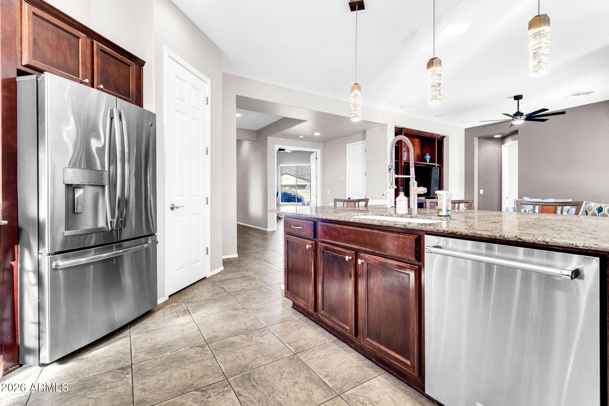 5333 South Marigold Way Gilbert, AZ 85298 - Photo 7 of 69 a kitchen with stainless steel appliances granite countertop a refrigerator a sink and a stove