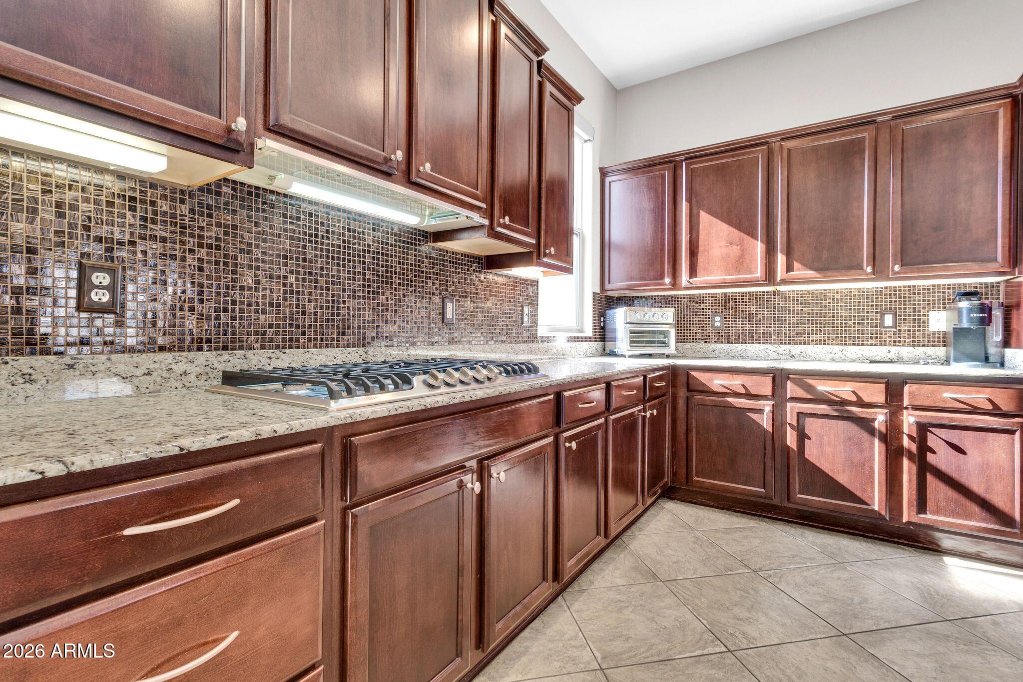 5333 South Marigold Way Gilbert, AZ 85298 - Photo 8 of 69 a kitchen with stainless steel appliances granite countertop wooden cabinets a sink and dishwasher