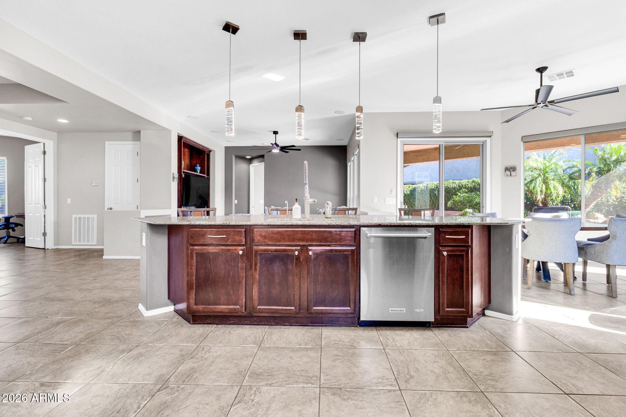 5333 South Marigold Way Gilbert, AZ 85298 - Photo 9 of 69 a kitchen with stainless steel appliances granite countertop a stove a sink and a wooden floors