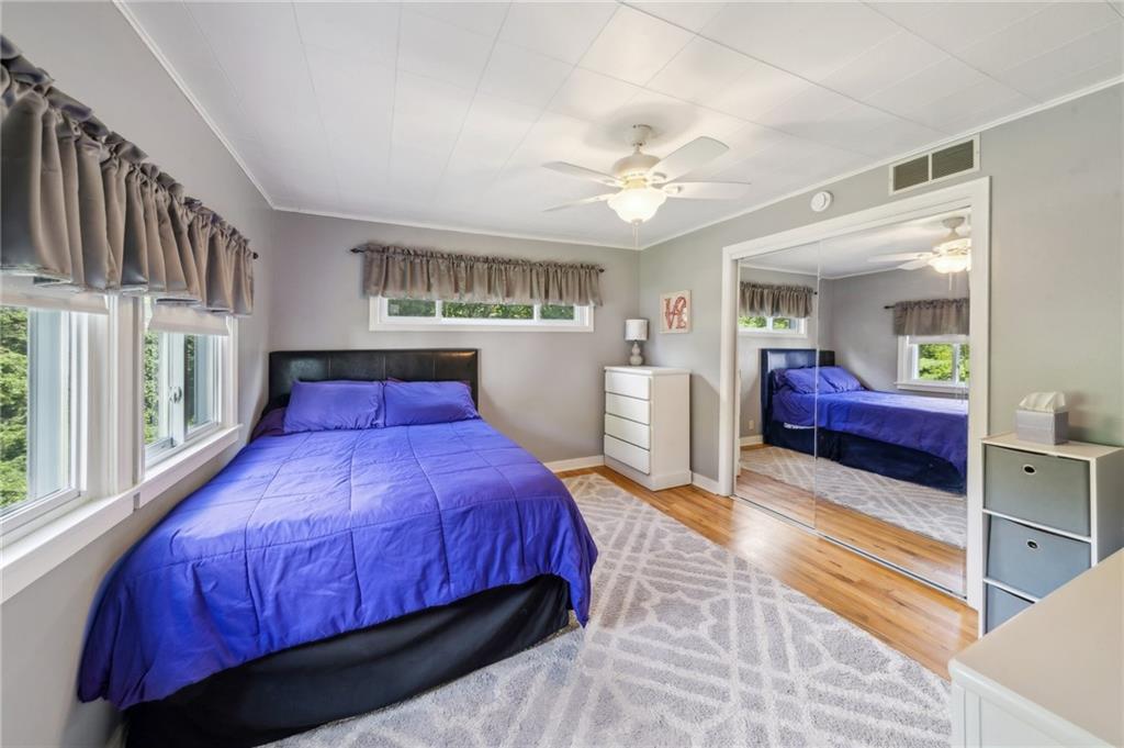 401 Finley Road Pittsburgh, PA 15239 - Photo 19 of 35 a bedroom with a large bed and a chandelier